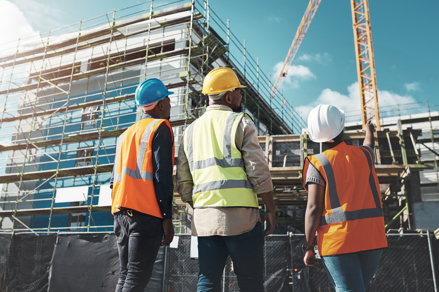 Construction workers observing building progress.