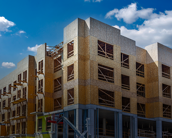 Building under construction with blue sky.